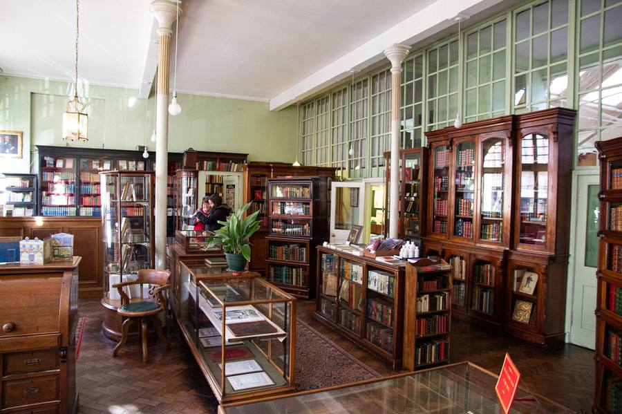 The shop interior at 23 Manvers Street, antiquarian shelves and reading chairs.